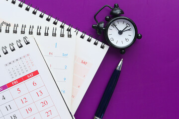 deadline concept with calendar and alarm clock purple background 