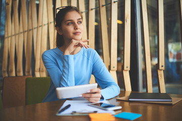 Dreamy beautiful teenager with big blue eyes looking away and thinking.Pensive young woman with...
