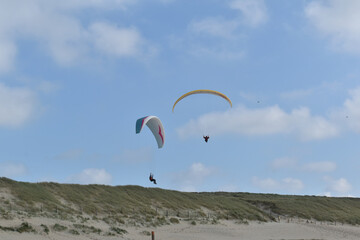 Paragliding at the beach of Katwijk aan Zee. Paraglider's making use of updraft of the dunes to stay in the air 