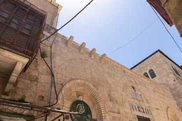 Fototapeta na wymiar Old buildings on Shaar Shalshelet Street in the Arab Quarter in the old city of Jerusalem, Israel