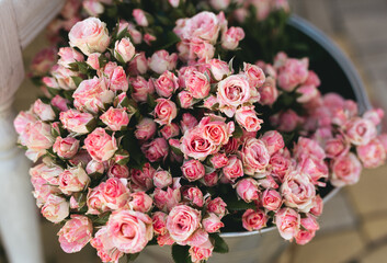 Pink  roses in a bucket. Beautiful anniversary decoration.