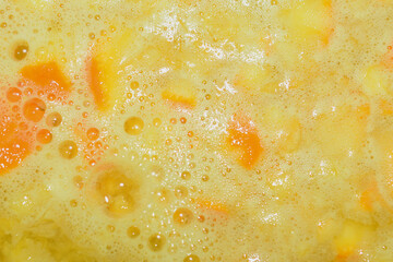 abstract background of orange juice in early stages of preparation