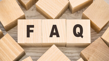 black letters faq on small wooden blocks and empty details