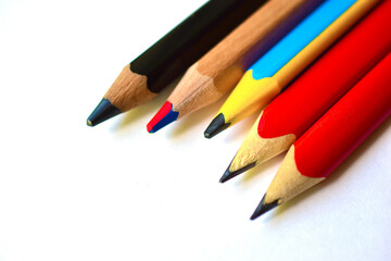 Multi-colored and large pencils on a white background