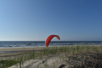 Paragliding at the beach of Katwijk aan Zee. Paraglider's making use of updraft of the dunes to stay in the air 