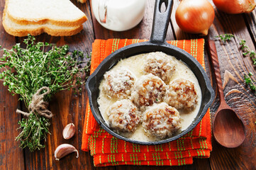 Meatballs with rice in a creamy sauce