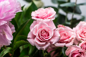 Pink rose and peony bouquet closeup with greenery