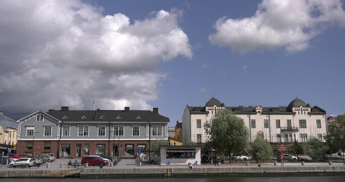4K video of Porvoo vintage red wooden buildings, Porvoo Cathedral, yachts and boats in Porvoonjoki River near town center on sunny summer day in Finland, northern Europe