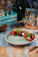 Caprese salad with horse meat salakis cheese