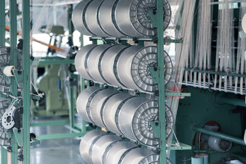 Naklejka na ściany i meble mechanical equipment at a garment factory. thread manufacturing tools.