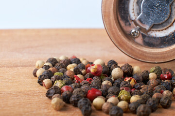 A mixture of peppers. Black, white, red polka dots. Isolated on a wooden background. The selected...