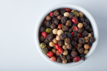 A mixture of peppers. Black, white, red polka dots. Isolated on a white background. The selected sharpness