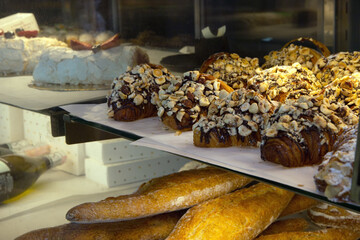 Pastry shop glass display with croissants a sweet sprinkle. selection focus