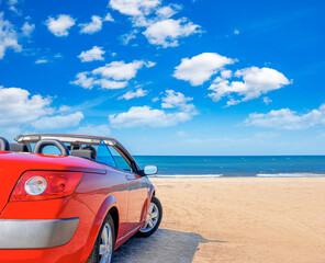 Fototapeta na wymiar Red car on the beach. Vacation and freedom concept.
