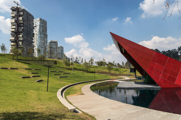 Open air forum and artifical lake inside La Mexicana urban park in Santa Fe, Mexico City, beside modern residential buildings
