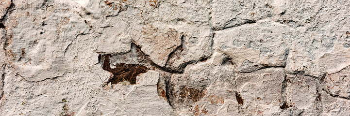 Texture of a concrete wall with cracks and scratches which can be used as a background