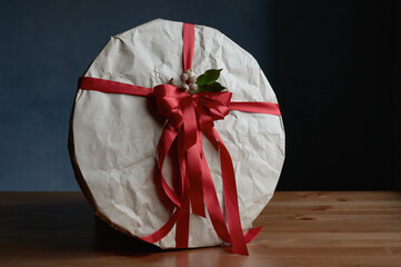 gift of craft paper with a red bow