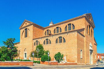 Fototapeta premium Cathedral Santa Maria Assunta Duomo Roman catholic church in Chioggia town historical centre, blue sky background in summer day, Veneto Region, Northern Italy