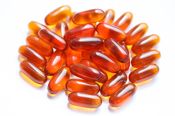 a handful of lecithin vitamins capsules on a white background