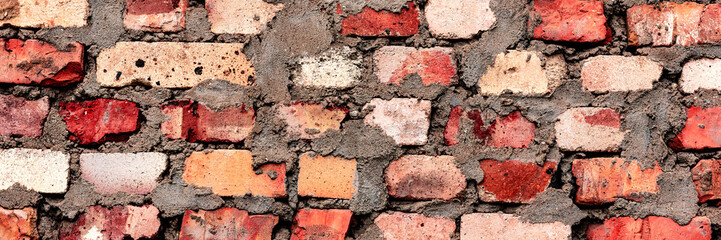 Texture of a brick wall with cracks and scratches which can be used as a background