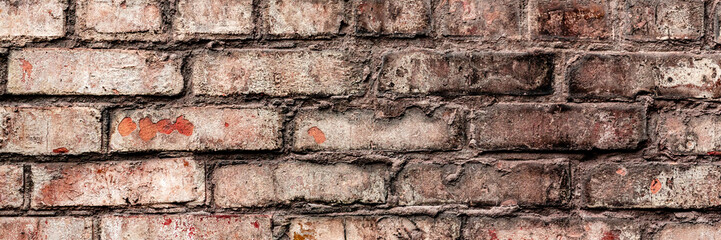 Obraz premium Texture of a brick wall with cracks and scratches which can be used as a background