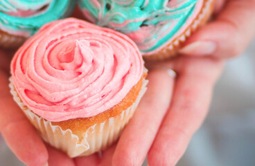 Close up female hold in hand blue-pink cake. Proper nutrition or sweets dessert fast food dieting morning concept