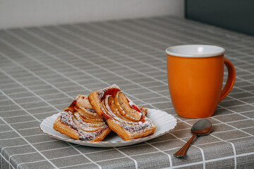 puff pastry puffs with Apple, cinnamon and powdered sugar, tea