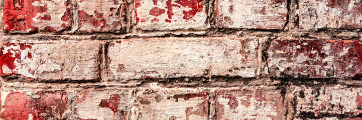 Texture of a brick wall with cracks and scratches which can be used as a background