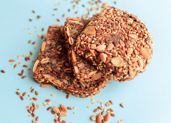 Sliced whole grain bread rye with seeds flax, sunflower, pumpkin and sesame.Healthy food, eco-friendly natural products. Fresh bread on a pink background.