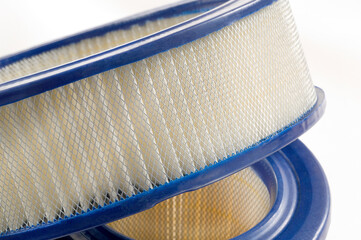 Air filter close-up used in vehicles 
Air filter showing multiple layers of filtering on white...