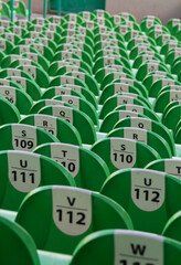 rows of green seats with white number labels