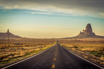 Agathla Peak, a volcanic plug north of Kayenta, Arizona viewed from Highway 163 as the sun is...