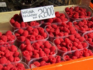 Expensive red raspberries in plastic box in a famous food market in Budapest, Hungary