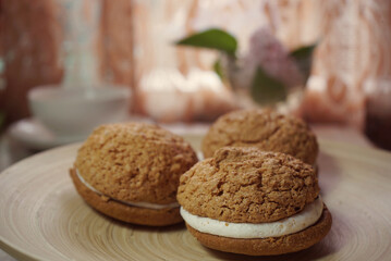 photo of delicious airy cakes on a wooden plate