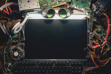 Blank computer screen with copy space and other digital accessories. Cyberpunk concept table...
