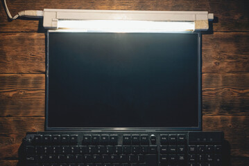 A blank computer screen with copy space and keyboard on the table flat lay background.