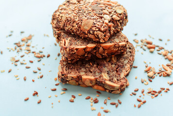 Sliced whole grain bread rye with seeds flax, sunflower, pumpkin and sesame.Healthy food, eco-friendly natural products. Fresh bread on a pink background.