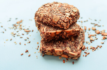 Sliced whole grain bread rye with seeds flax, sunflower, pumpkin and sesame.Healthy food, eco-friendly natural products. Fresh bread on a pink background.