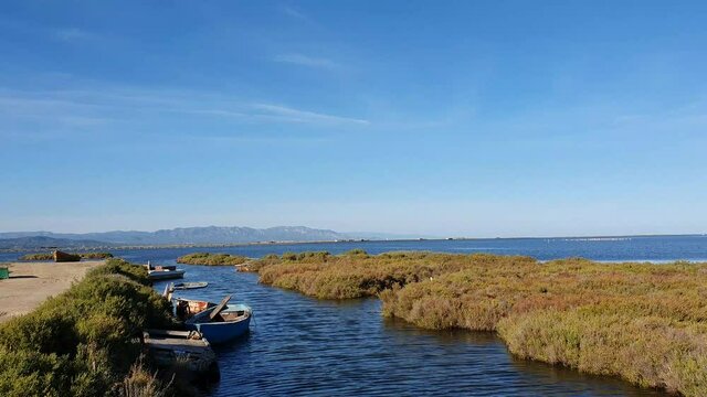 Traditional Wooden Fishing Boat moored in the Ebro Delta National Park in a Water Canal, near Amposta, Province of Tarragona, Catalonia, Spain