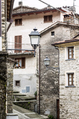 Fototapeta na wymiar Scenic street with houses in a cozy little town in Italian mountains of Apuan Alps