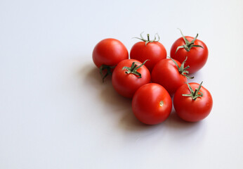ripe tomatoes on a white background close up