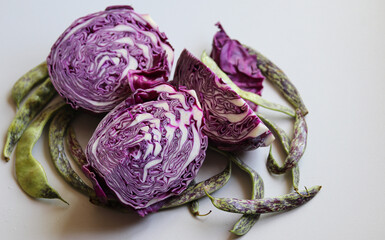 sliced red cabbage and string beans on a white background