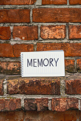 inscription memory on the background of an old brick wall