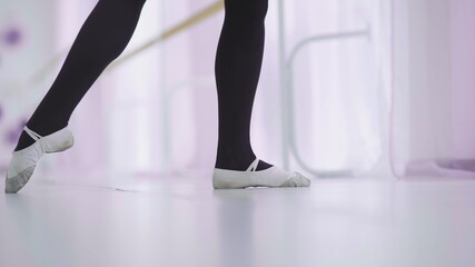Dance of the ballerina. Female ballet dancer dancing in pointe shoes in studio. © stanis88