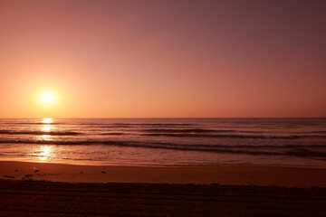 Fototapeta na wymiar Sunrise on lonely beach,