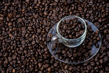 coffee beans in a cup and around the cup