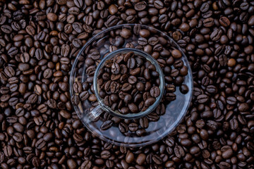 coffee beans in a cup and around the cup