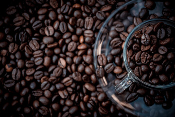 coffee beans in a cup and around the cup