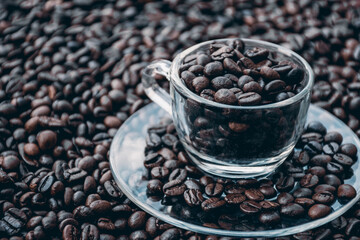 coffee beans in a cup and around the cup