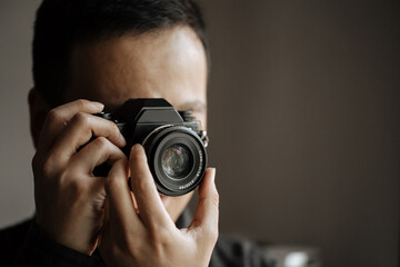 man taking a picture on a pentax film camera.